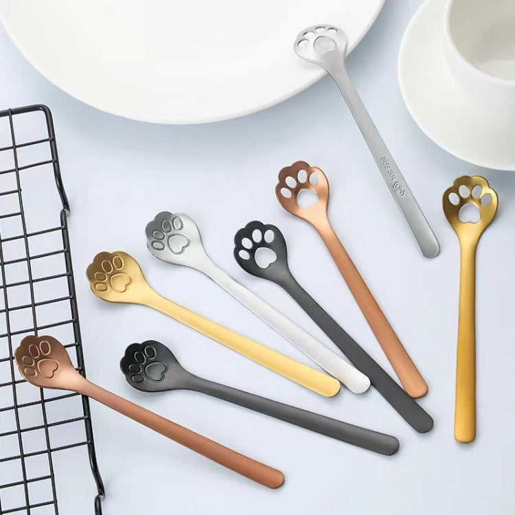 A stainless steel coffee stirring spoon designed like a cartoon cat paw, showcasing its polished finish and ergonomic handle.