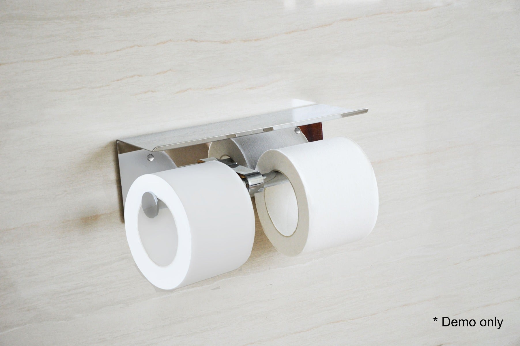 Stainless Steel Double Toilet Paper Holder with decorative shelf, showcasing its sleek design and functionality.