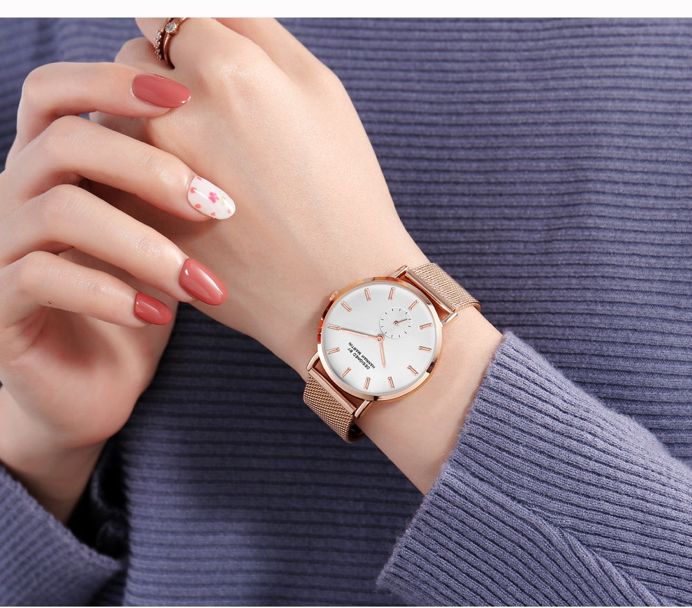 A stylish black ladies watch featuring a stainless steel mesh band and a round 36mm case, showcasing a sleek design with Japan quartz movement.