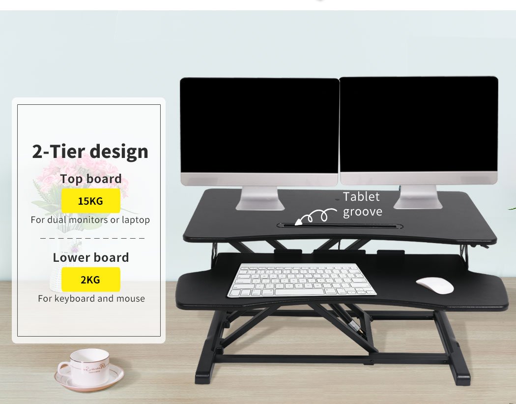 Height adjustable standing desk riser with two-tier design, featuring a sturdy top surface for monitors and a detachable lower deck for keyboard and mouse.