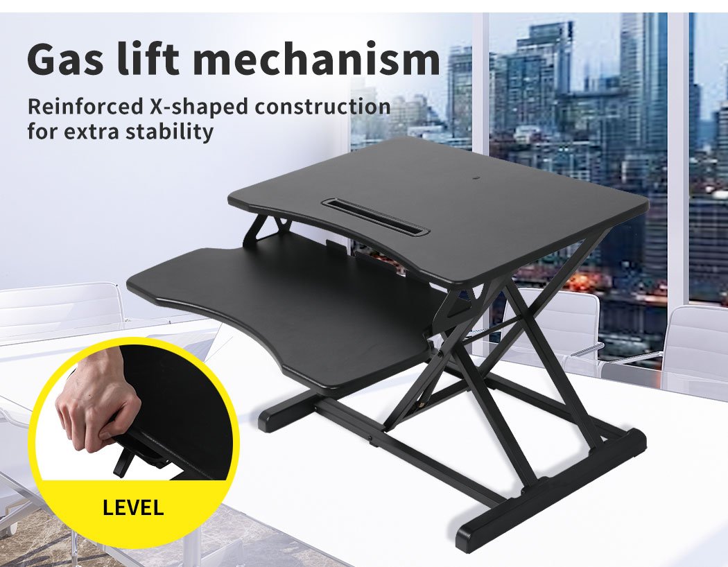 Height adjustable standing desk riser with two-tier design, featuring a sturdy top surface for monitors and a detachable lower deck for keyboard and mouse.