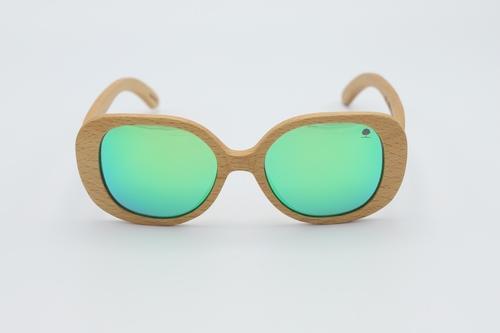 Stylish Star Sunglasses featuring oversized round frames made from premium zebra wood with green polarized lenses.