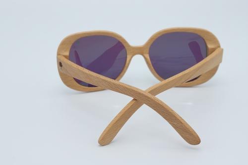 Stylish Star Sunglasses featuring oversized round frames made from premium zebra wood with green polarized lenses.