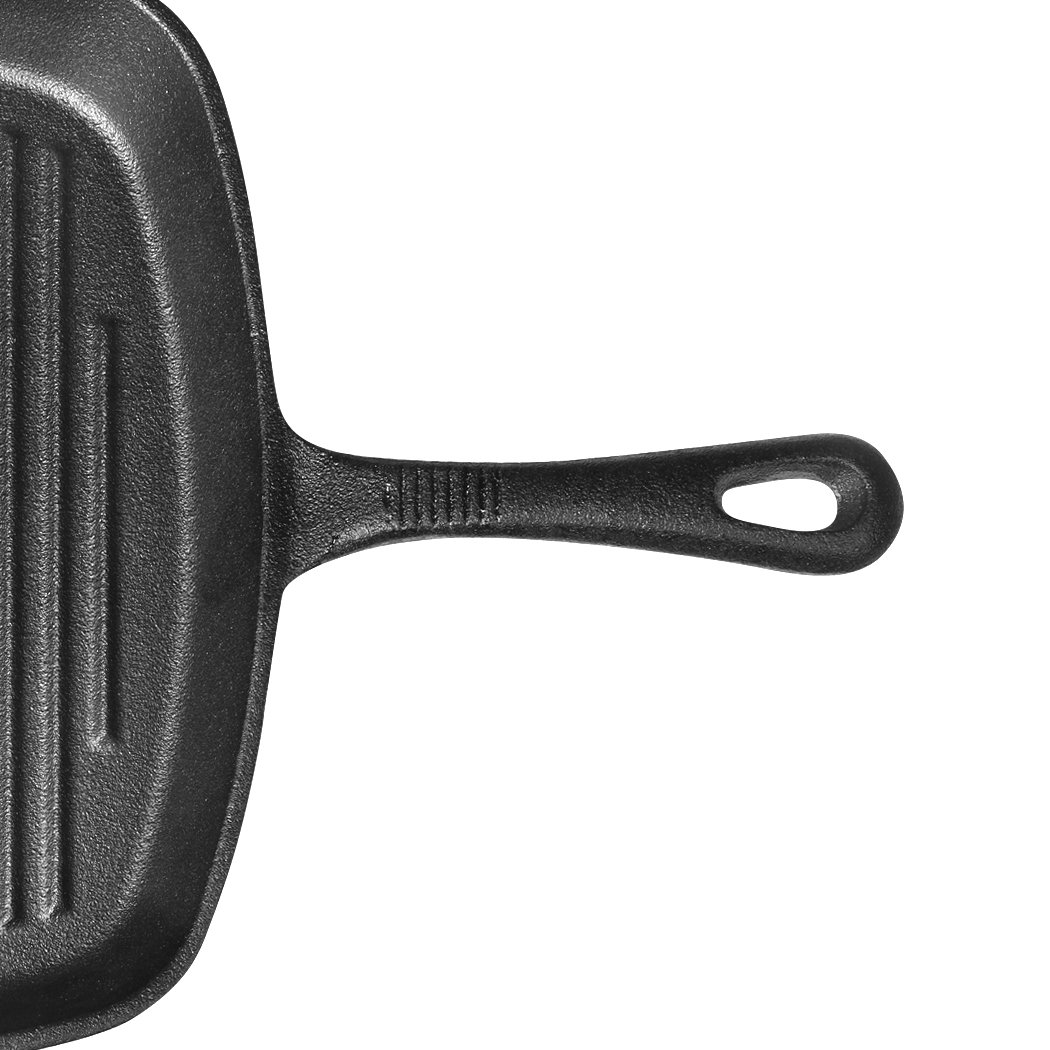 A sleek grey Steak Frying Pan made of FDA cast iron, featuring a non-stick ribbed surface and an anti-slip handle, ideal for gas and induction cookers.