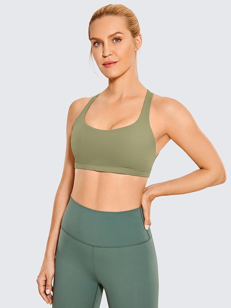 A stylish strappy sports bra for women featuring a cross-back design, padded support, and made from breathable fabric, ideal for yoga and fitness activities.