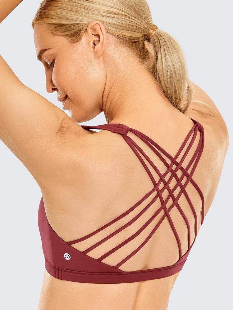 A stylish strappy sports bra for women featuring a cross-back design, padded support, and made from breathable fabric, ideal for yoga and fitness activities.