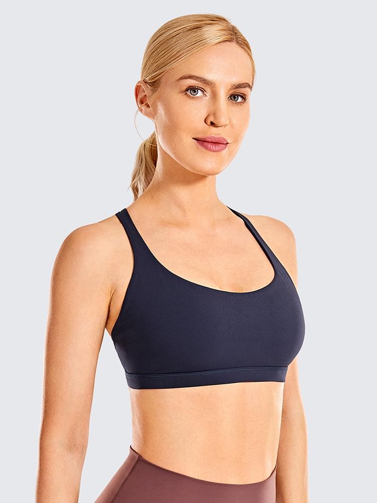 A stylish strappy sports bra for women featuring a cross-back design, padded support, and made from breathable fabric, ideal for yoga and fitness activities.