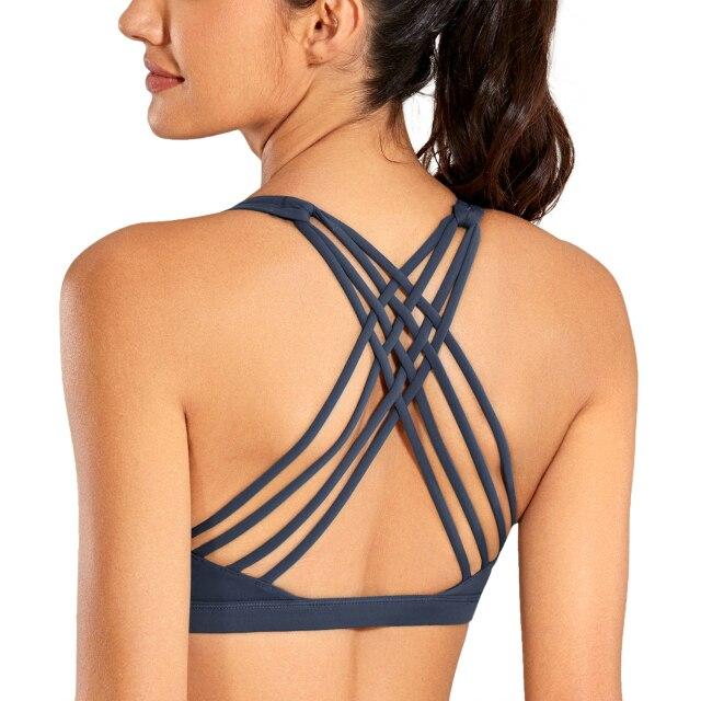 A stylish strappy sports bra for women featuring a cross-back design, padded support, and made from breathable fabric, ideal for yoga and fitness activities.