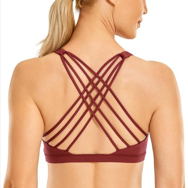 A stylish strappy sports bra for women featuring a cross-back design, padded support, and made from breathable fabric, ideal for yoga and fitness activities.