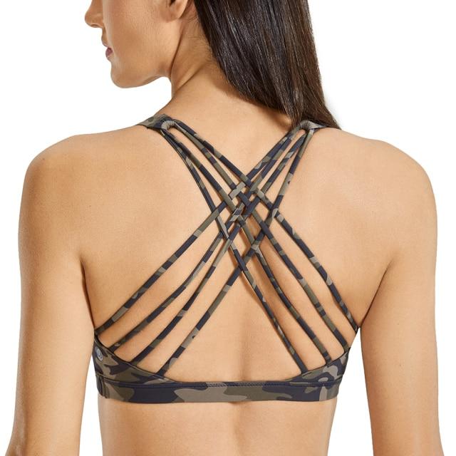 A stylish strappy sports bra for women featuring a cross-back design, padded support, and made from breathable fabric, ideal for yoga and fitness activities.