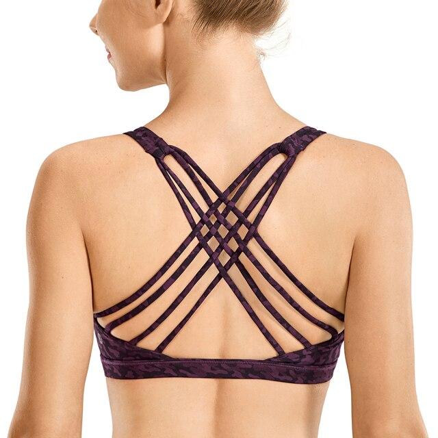 A stylish strappy sports bra for women featuring a cross-back design, padded support, and made from breathable fabric, ideal for yoga and fitness activities.