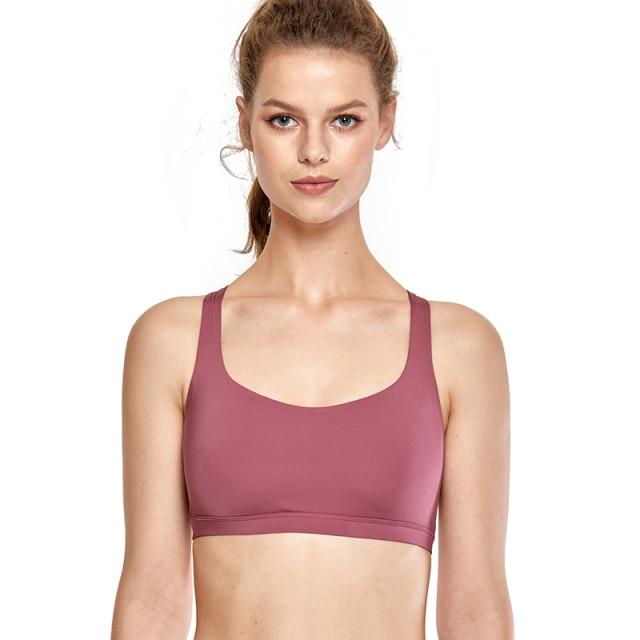 A stylish strappy sports bra for women featuring a cross-back design, padded support, and made from breathable fabric, ideal for yoga and fitness activities.