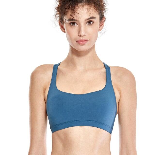 A stylish strappy sports bra for women featuring a cross-back design, padded support, and made from breathable fabric, ideal for yoga and fitness activities.