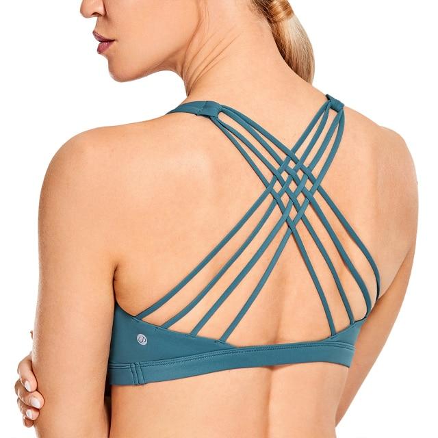 A stylish strappy sports bra for women featuring a cross-back design, padded support, and made from breathable fabric, ideal for yoga and fitness activities.