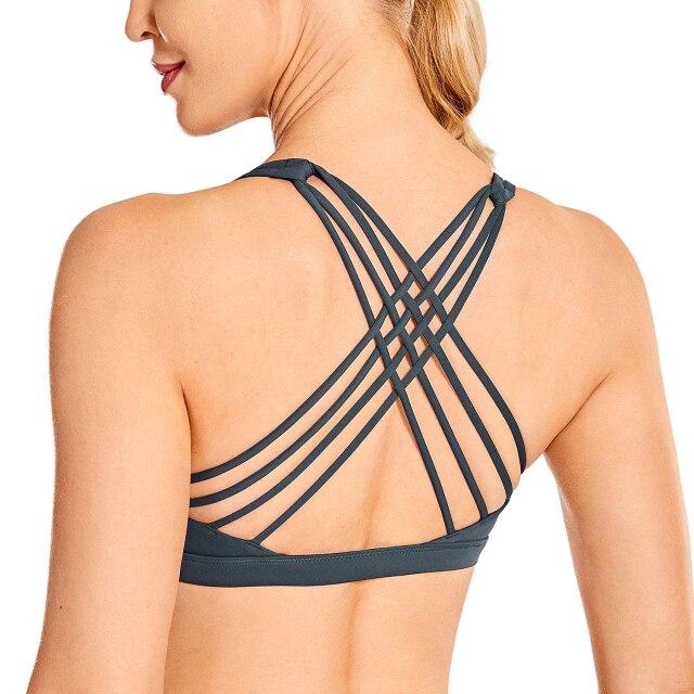 A stylish strappy sports bra for women featuring a cross-back design, padded support, and made from breathable fabric, ideal for yoga and fitness activities.