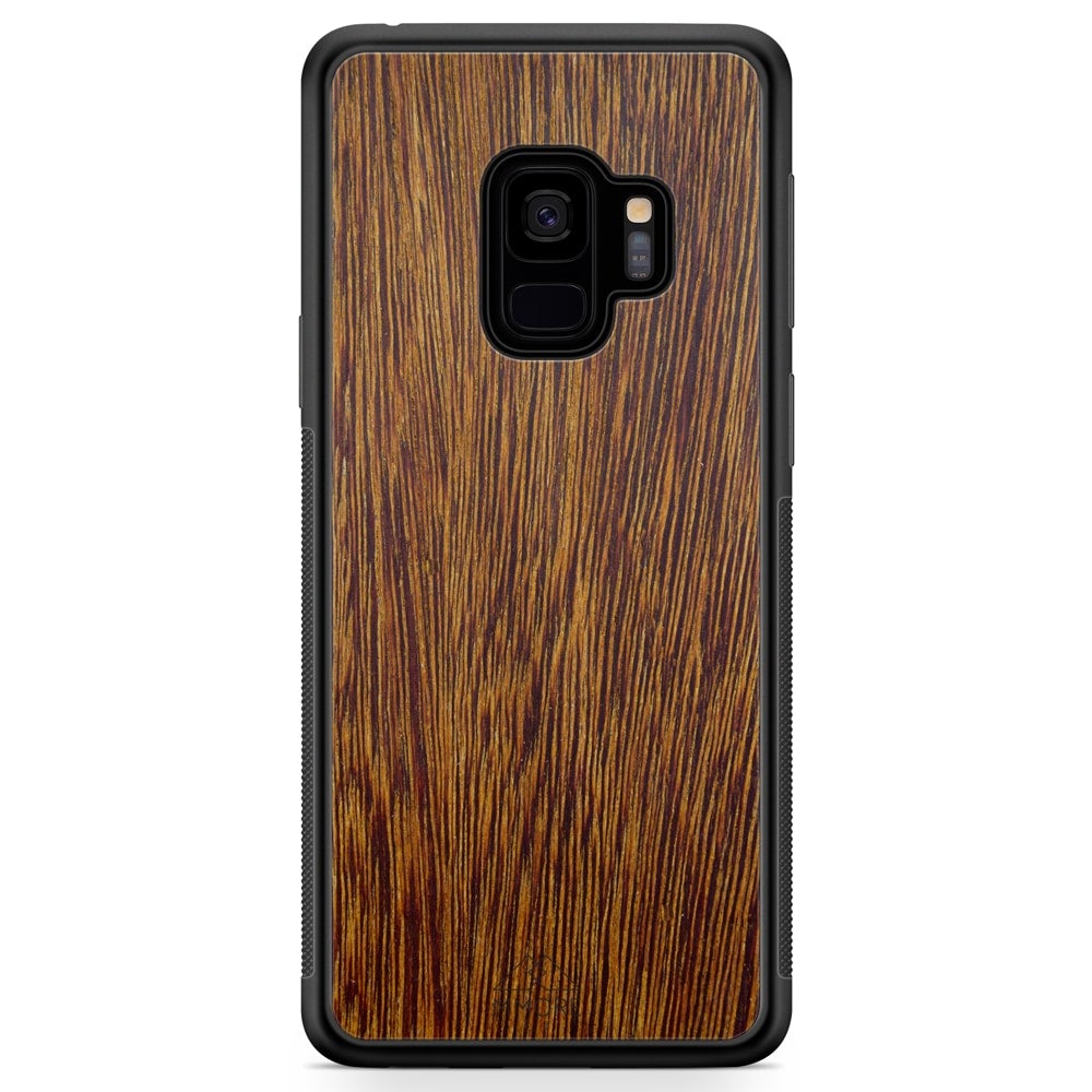 Sucupira wooden phone case held in hand, showcasing its unique grain and finish.