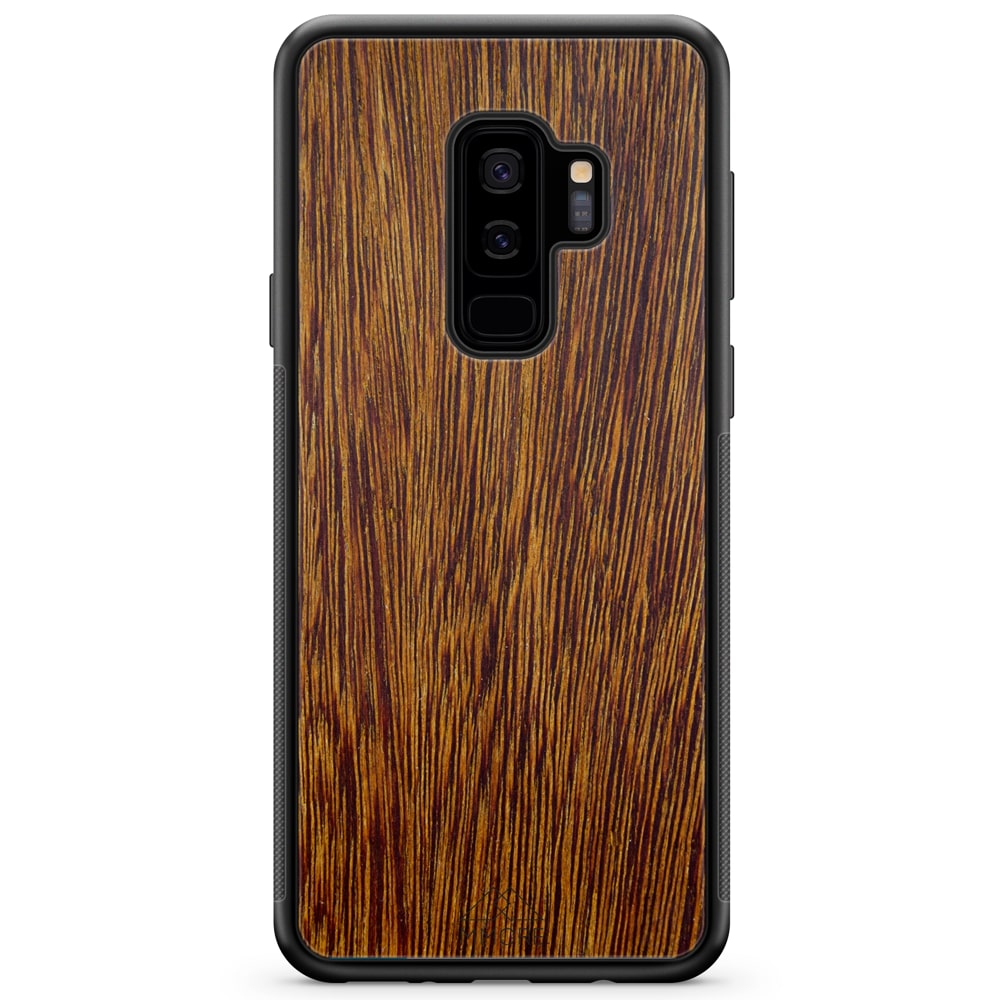 Sucupira wooden phone case held in hand, showcasing its unique grain and finish.