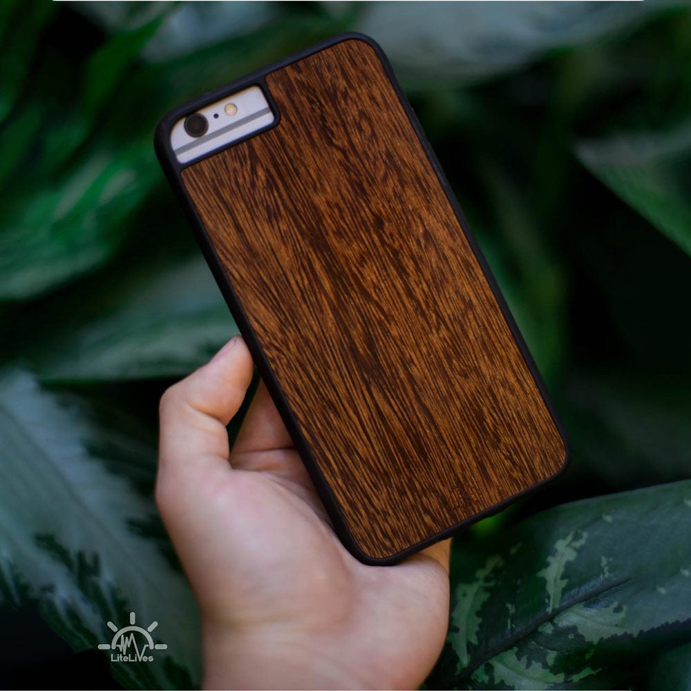 Sucupira wooden phone case held in hand, showcasing its unique grain and finish.