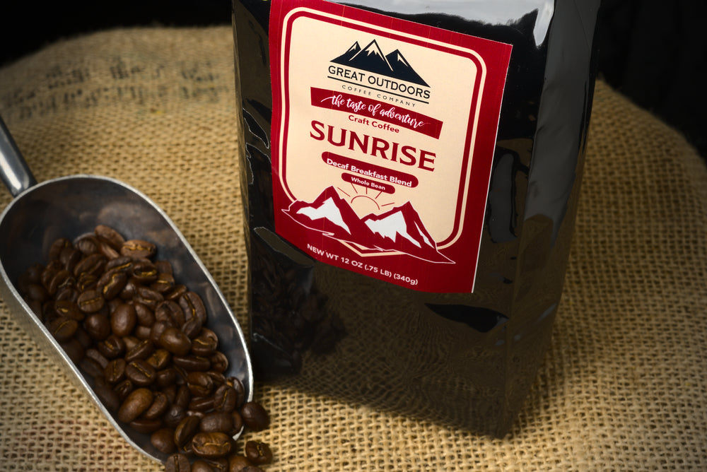 A bag of Sunrise Decaf coffee blend featuring Central American beans with hints of orange and caramel.