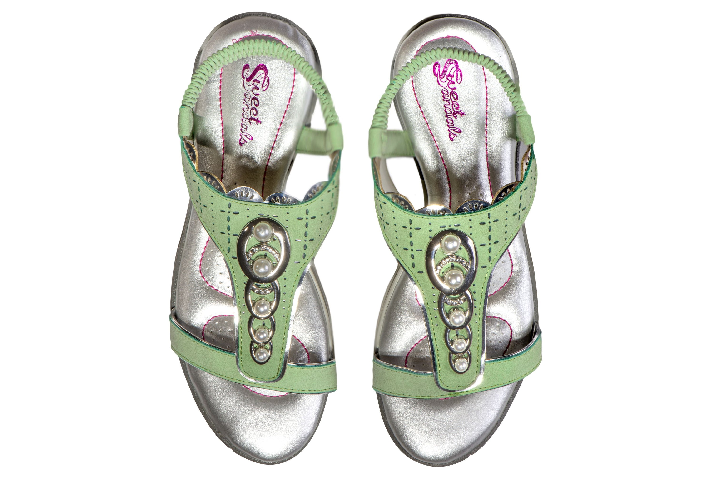 A pair of stylish Sweet Sandals featuring a slip-on design with pink stitching and faux jewel embellishments, perfect for golf or walking.