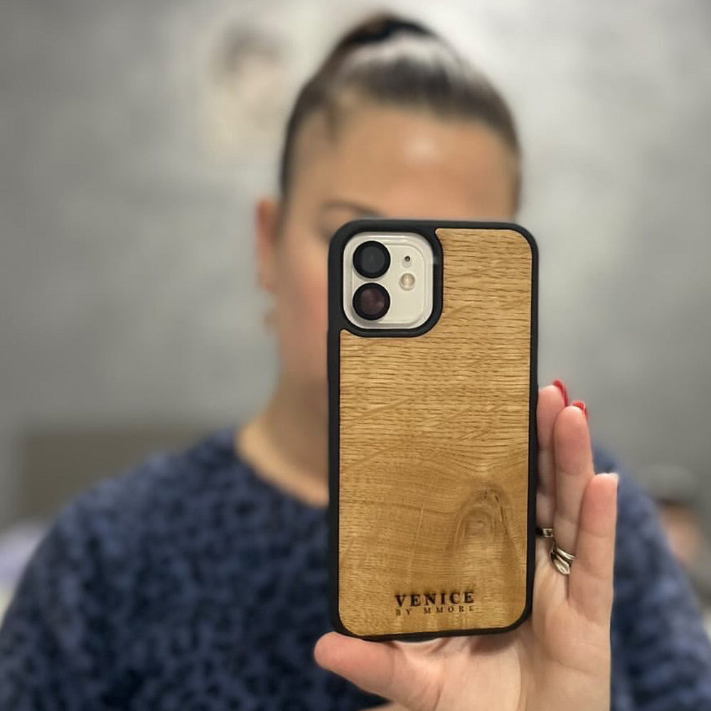 Handcrafted Venice case made from ancient oak wood with minimalist lettering design, showcasing its unique texture and craftsmanship.