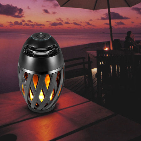 Tiki Tiki To To Outdoor LED Torch with Bluetooth Speaker, featuring a flickering LED flame and adjustable pole for outdoor parties.