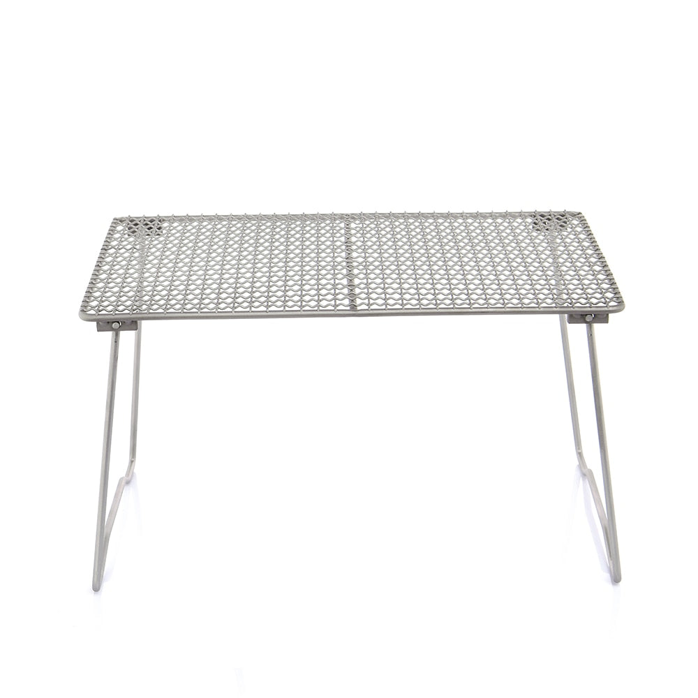 Titanium Charcoal BBQ Grill Net with folding legs, ideal for camping and beach picnics, showcasing its durable design and portability.