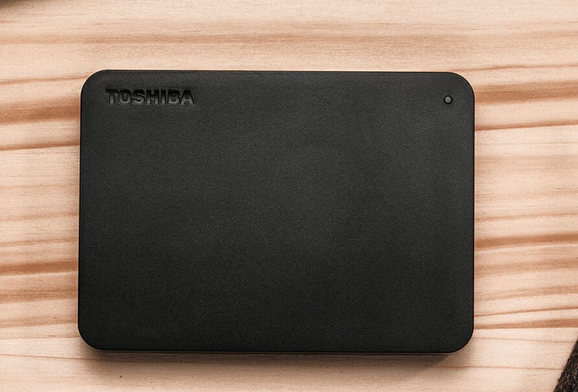 TOSHIBA 2TB Canvio Basics Portable Hard Drive in sleek black design, showcasing USB 3.0 port and compact size.