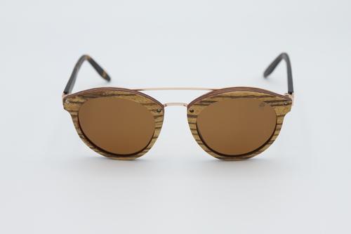 Stylish Trend Sunglasses made from zebra skateboard wood with brown polarized lenses and spring metal hinges, displayed in an eco-friendly wood box.