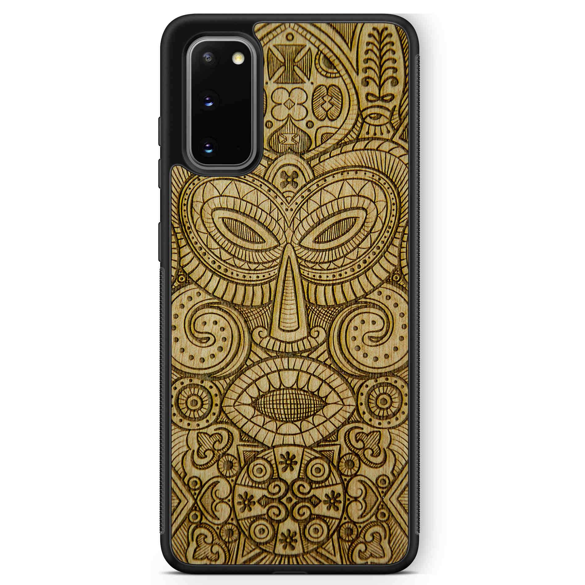 Tribal Mask wooden phone case held in hand, showcasing its unique design and natural wood grain.