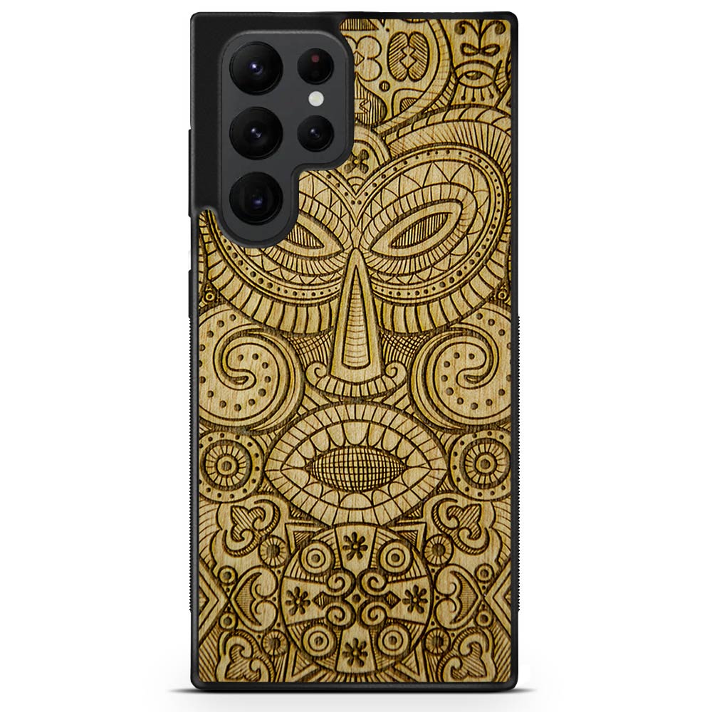 Tribal Mask wooden phone case held in hand, showcasing its unique design and natural wood grain.