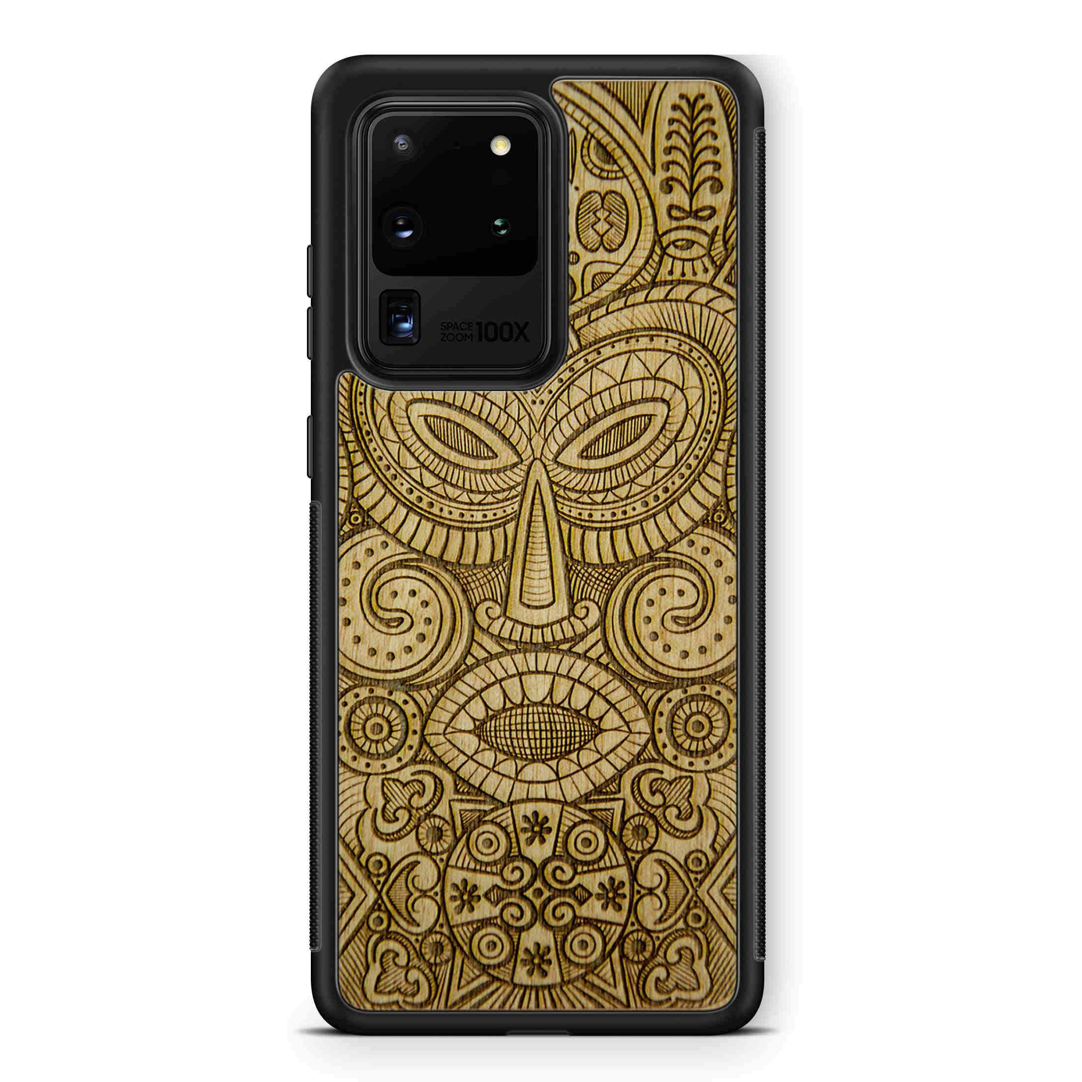 Tribal Mask wooden phone case held in hand, showcasing its unique design and natural wood grain.