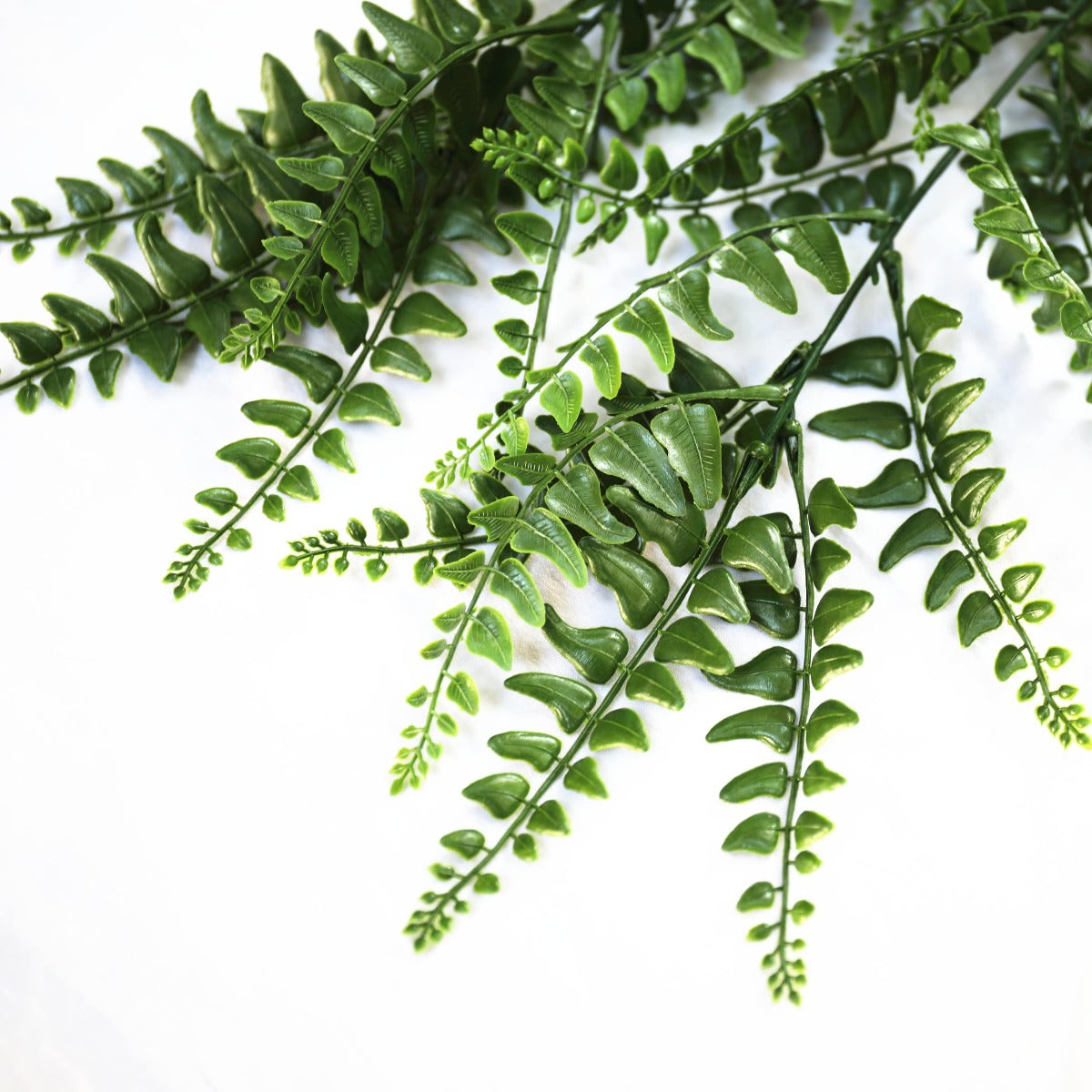 A lush, realistic UV Resistant Dense Hanging Fern measuring 90cm, perfect for indoor and outdoor decor, showcasing vibrant green leaves.