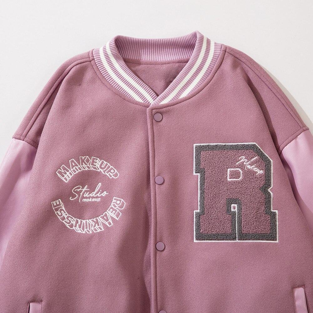 Men's varsity jacket featuring leather patchwork and letter patches, available in black and pink colors.