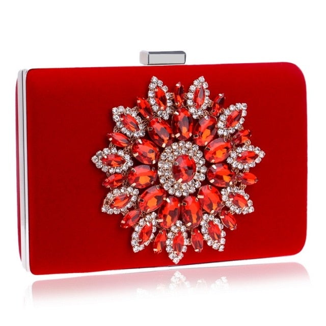 A luxurious velvet evening bag for women featuring a rhinestone flower design, perfect for parties and formal occasions.