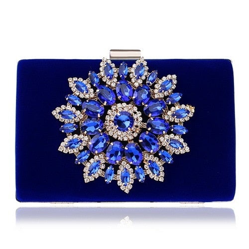 A luxurious velvet evening bag for women featuring a rhinestone flower design, perfect for parties and formal occasions.