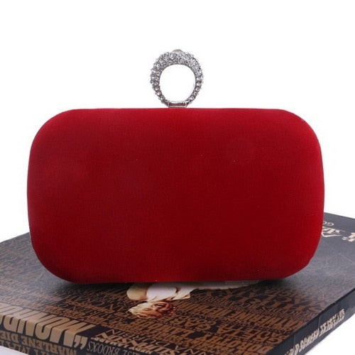 A luxurious velvet evening bag for women featuring a rhinestone flower design, perfect for parties and formal occasions.