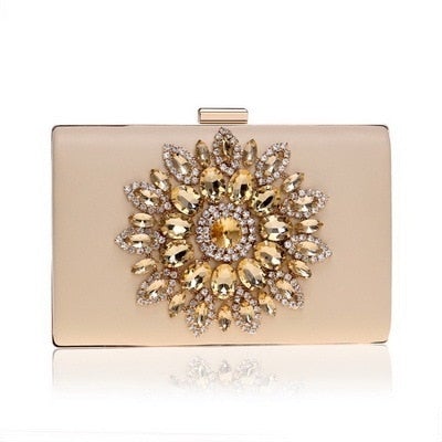 A luxurious velvet evening bag for women featuring a rhinestone flower design, perfect for parties and formal occasions.