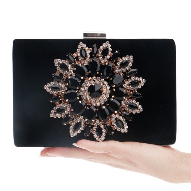 A luxurious velvet evening bag for women featuring a rhinestone flower design, perfect for parties and formal occasions.