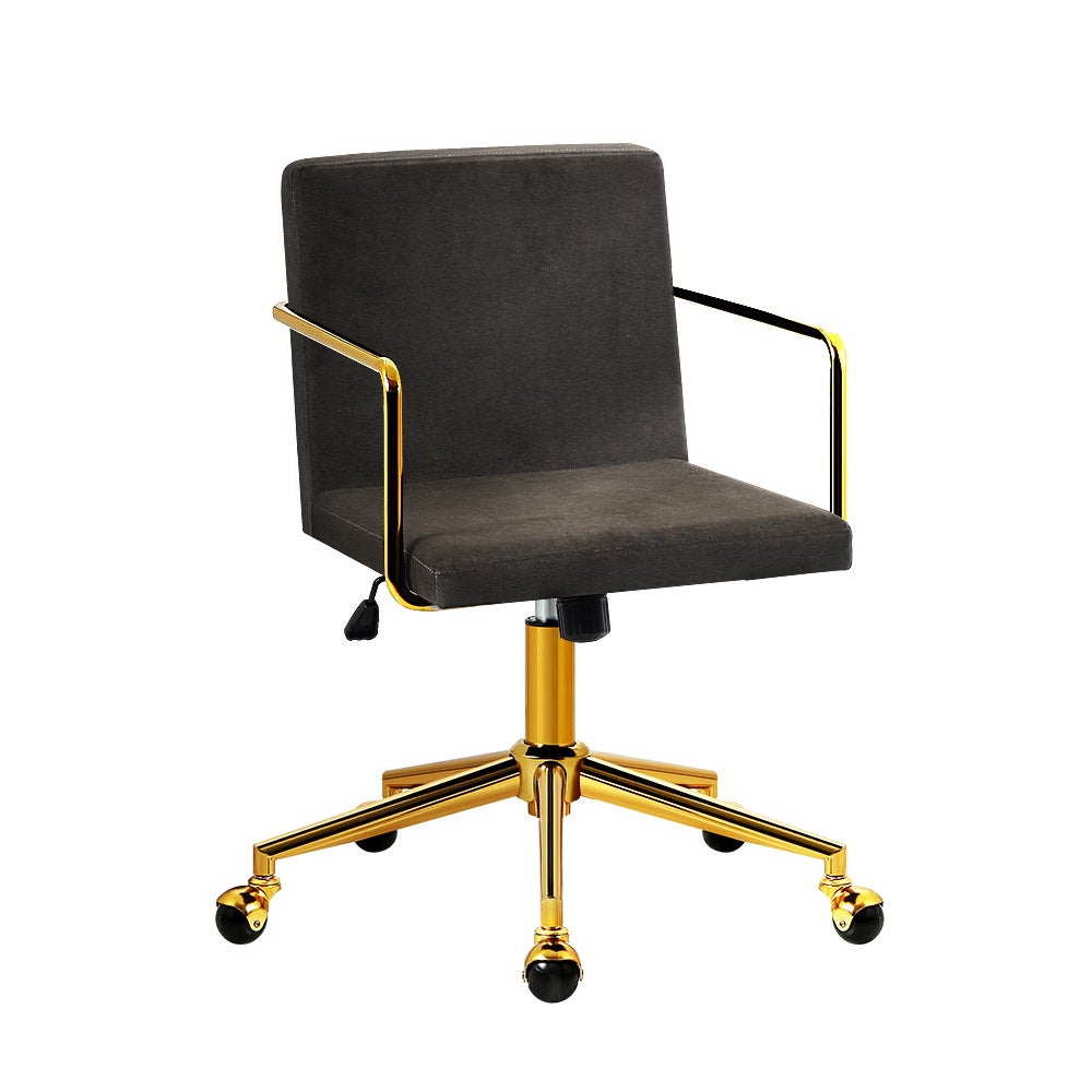 Caraway Velvet Office Chair with metallic brass base and armrests, showcasing luxurious charcoal upholstery and smooth castor wheels.