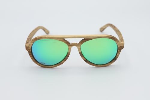 Vision Sunglasses made from premium zebra wood with green polarized lenses, displayed in a stylish wood box.