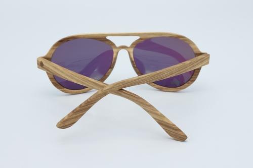 Vision Sunglasses made from premium zebra wood with green polarized lenses, displayed in a stylish wood box.