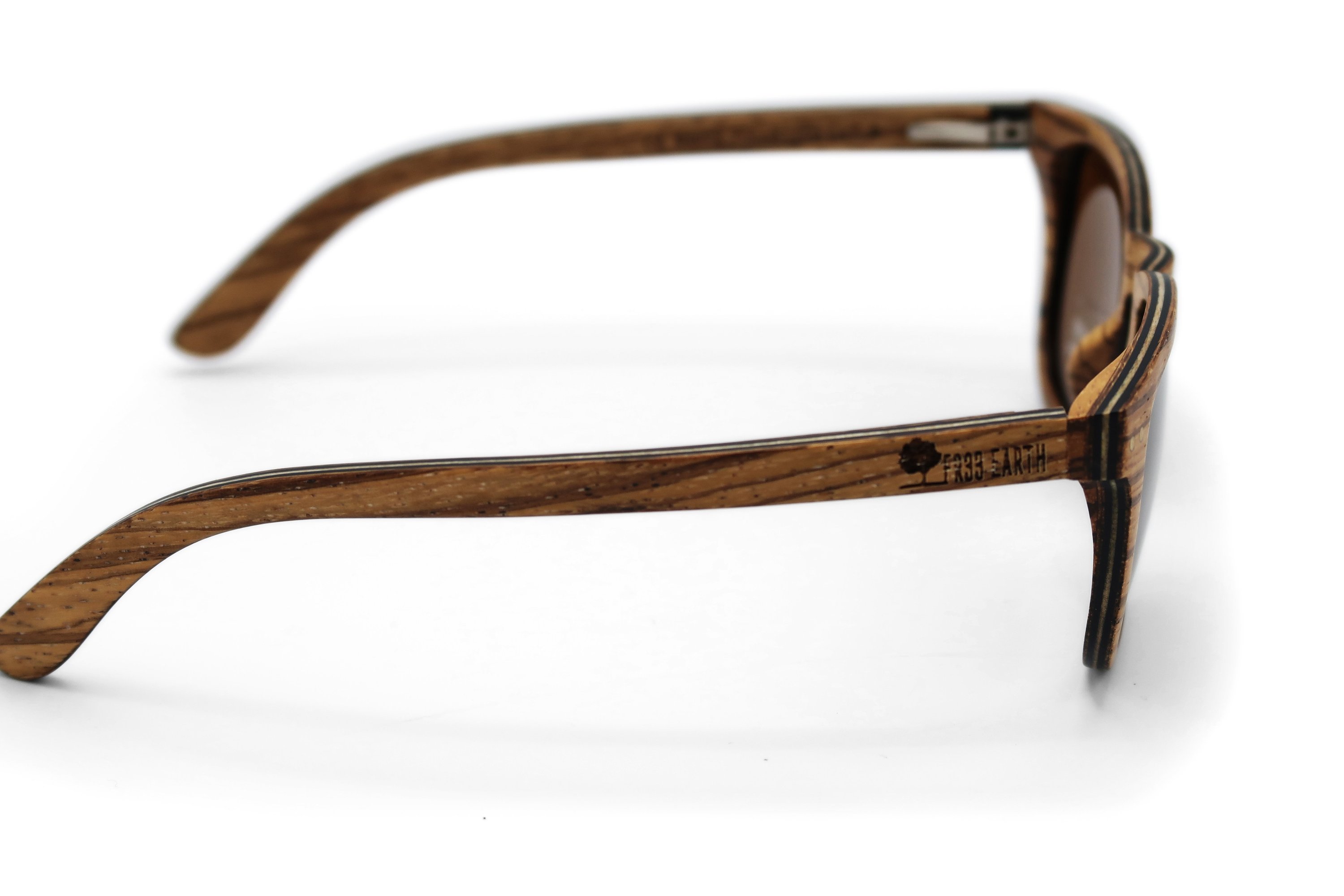 Wave Zebra Sunglasses featuring a unique zebra wood frame and polarized lenses, elegantly displayed in eco-friendly packaging.