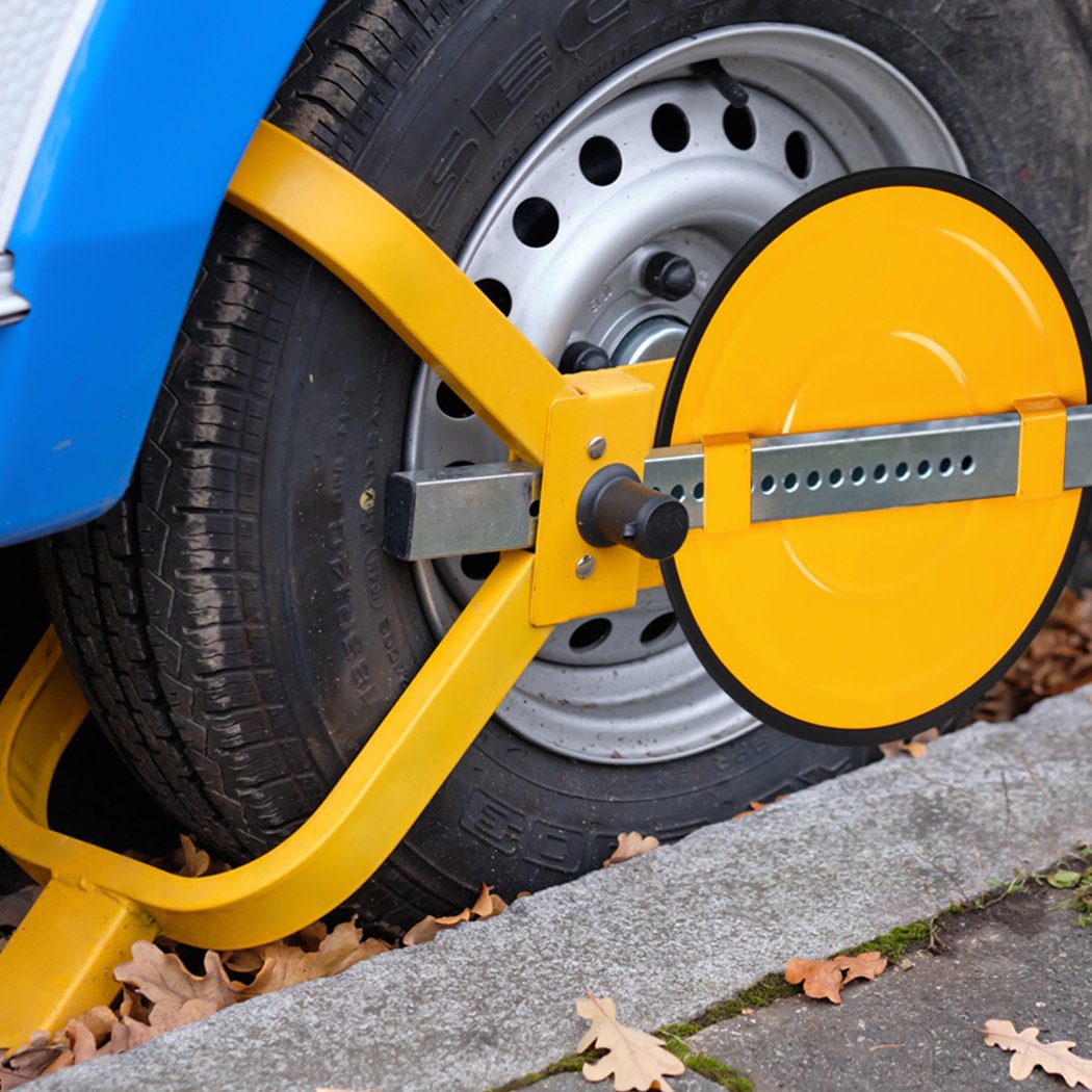 Heavy-duty yellow wheel lock clamp designed for vehicle security, featuring an adjustable locking system and two keys.