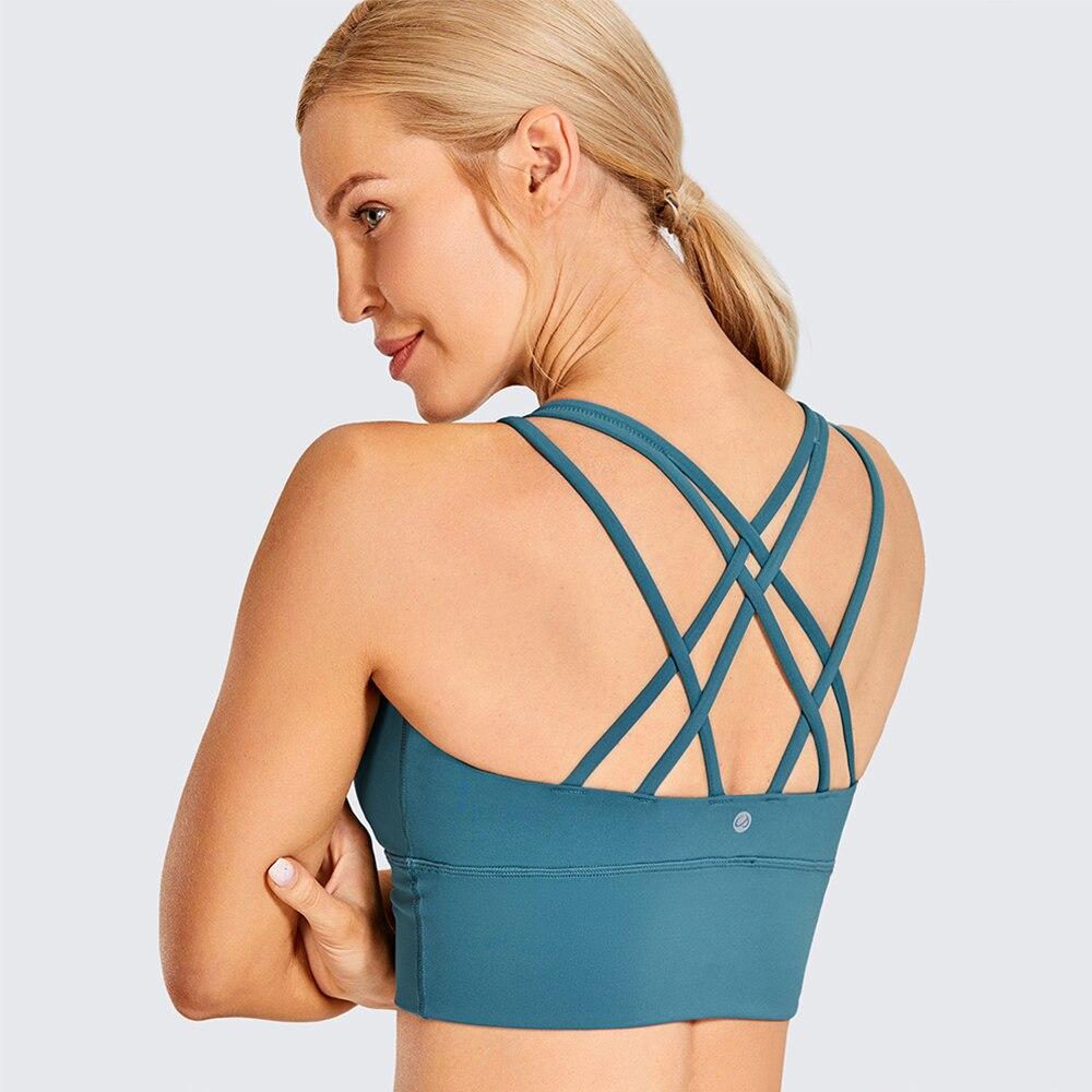 A stylish wirefree padded strappy yoga bra in a longline design, perfect for medium impact sports and yoga, showcasing its breathable fabric and trendy straps.