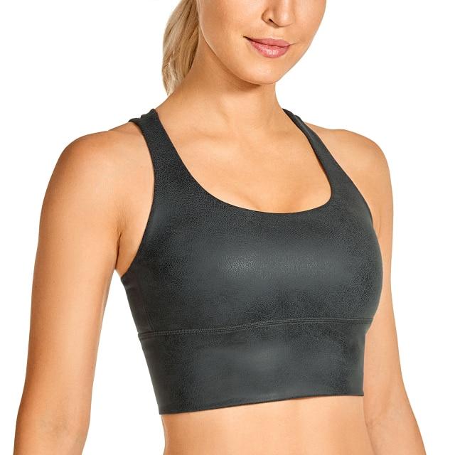 A stylish wirefree padded strappy yoga bra in a longline design, perfect for medium impact sports and yoga, showcasing its breathable fabric and trendy straps.