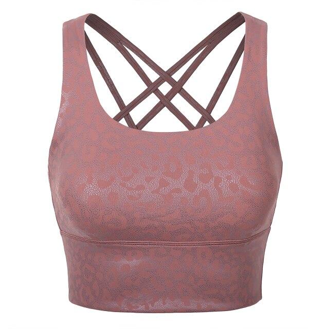 A stylish wirefree padded strappy yoga bra in a longline design, perfect for medium impact sports and yoga, showcasing its breathable fabric and trendy straps.