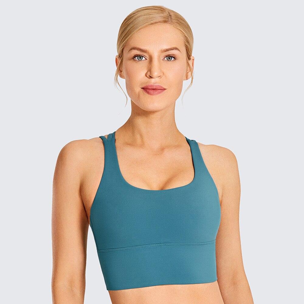 A stylish wirefree padded strappy yoga bra in a longline design, perfect for medium impact sports and yoga, showcasing its breathable fabric and trendy straps.