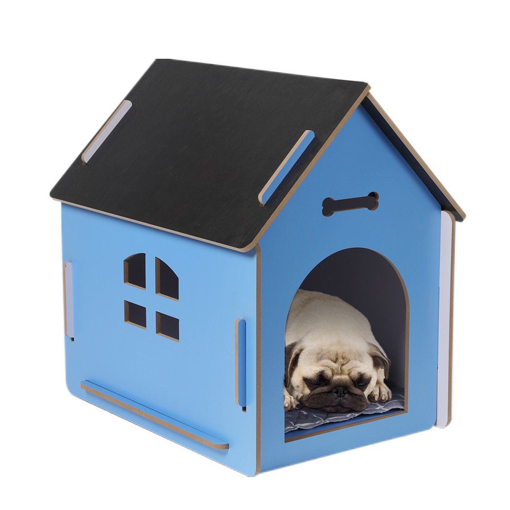 A large blue wooden dog house with an arch door, designed for indoor use, featuring ventilation windows and a cozy pet bed inside.