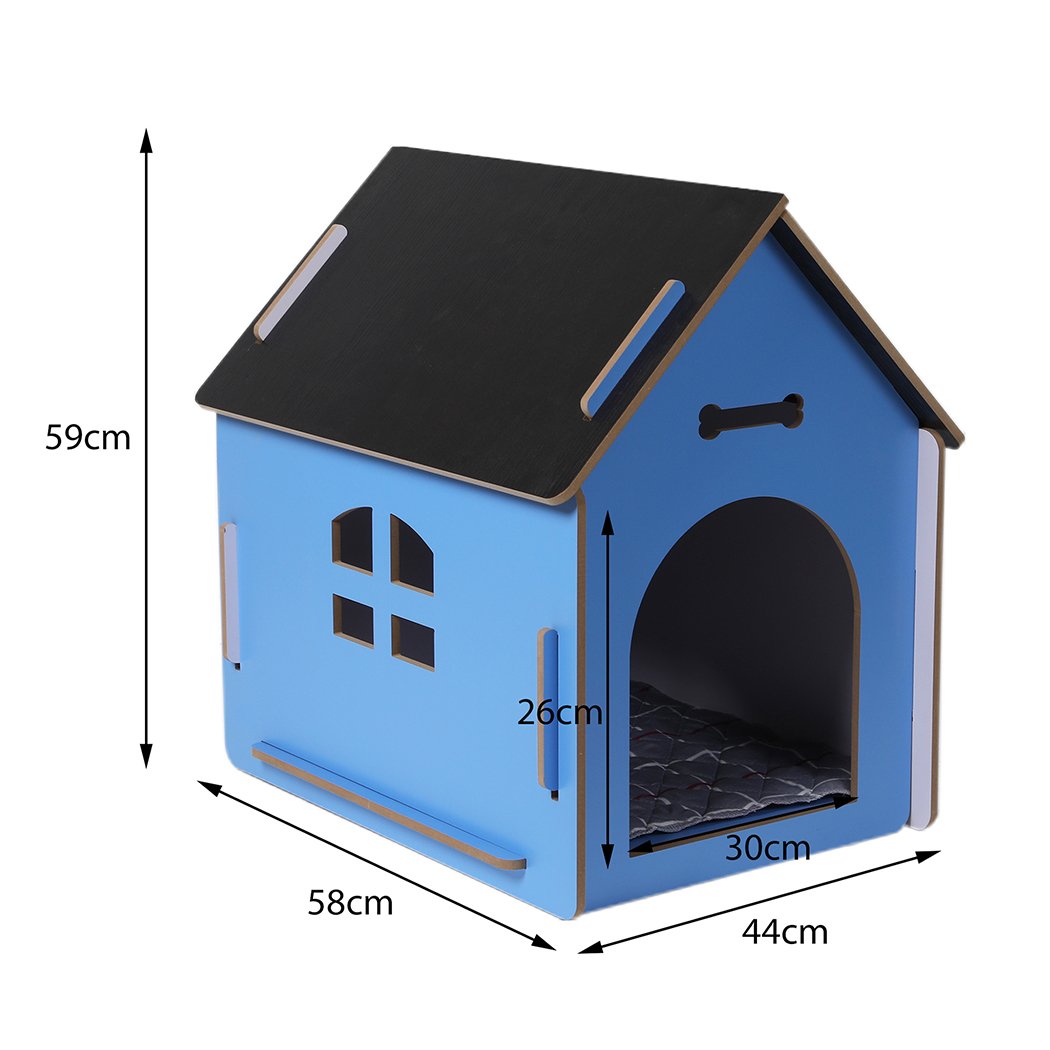 A large blue wooden dog house with an arch door, designed for indoor use, featuring ventilation windows and a cozy pet bed inside.